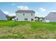 View of the home's backyard, showing a partially grassy area and neighboring houses at 3915 Allenby Pl, Monroe, NC 28110