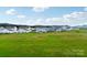 View of the community from the backyard, showing other houses and green space at 3915 Allenby Pl, Monroe, NC 28110