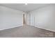 Well-lit bedroom with carpet and access to hallway at 3915 Allenby Pl, Monroe, NC 28110