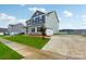 Two-story house exterior with blue and green siding, landscaping and driveway at 3915 Allenby Pl, Monroe, NC 28110