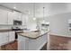 Modern kitchen with white cabinets, granite countertops, and stainless steel appliances at 3915 Allenby Pl, Monroe, NC 28110