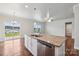 Modern kitchen with white cabinets, granite countertops, and stainless steel appliances at 3915 Allenby Pl, Monroe, NC 28110