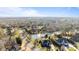 Aerial view of neighborhood with a large pond and fountain, surrounded by mature trees and manicured lawns at 4008 Quintessa Dr, Matthews, NC 28104