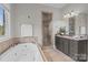 This bathroom features double vanities, a jetted tub, and a glass-enclosed shower, perfect for relaxation at 4008 Quintessa Dr, Matthews, NC 28104