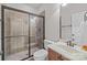 Well-lit bathroom features glass shower, tile surround, and vanity with storage at 4008 Quintessa Dr, Matthews, NC 28104