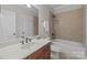 Bathroom featuring a vanity, shower-tub combo, and neutral tile, creating a practical and stylish design at 4008 Quintessa Dr, Matthews, NC 28104
