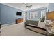 Primary bedroom with a sitting area, ceiling fan, and ample natural light at 4008 Quintessa Dr, Matthews, NC 28104