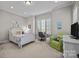 Bright bedroom featuring a white bed frame, a cozy reading chair, and a study desk near the window at 4008 Quintessa Dr, Matthews, NC 28104