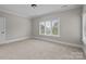Bedroom with neutral carpet, crown molding, and a large window with blinds at 4008 Quintessa Dr, Matthews, NC 28104