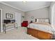 Neutral bedroom featuring a bed, desk, and carpeted floors with a large window providing natural light at 4008 Quintessa Dr, Matthews, NC 28104