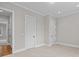 Light, neutral bedroom showcasing trim, base molding, and multiple entry doors, creating an airy, functional space at 4008 Quintessa Dr, Matthews, NC 28104