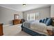 Spacious bedroom with large window, light-colored carpet, and a bed with blue and white bedding at 4008 Quintessa Dr, Matthews, NC 28104