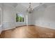 Elegant dining room with hardwood floors, wainscoting, and a chandelier at 4008 Quintessa Dr, Matthews, NC 28104