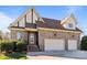 Charming brick home showcasing a two-car garage and a welcoming front entrance at 4008 Quintessa Dr, Matthews, NC 28104