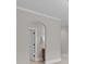 Arched hallway showcasing neutral paint and trim, providing an elegant transition between rooms at 4008 Quintessa Dr, Matthews, NC 28104