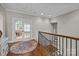 Hallway with hardwood floors, a staircase, and doors leading to other rooms at 4008 Quintessa Dr, Matthews, NC 28104