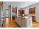 Kitchen with large island, tile backsplash and wooden cabinetry offering lots of storage space at 4008 Quintessa Dr, Matthews, NC 28104