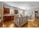 Open kitchen featuring a large island with granite countertops and views into the dining area at 4008 Quintessa Dr, Matthews, NC 28104