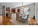 Bright kitchen with a dining area, wood floors, and natural light streaming through the windows at 4008 Quintessa Dr, Matthews, NC 28104