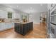 Modern kitchen with a large island, granite countertops, and stainless steel appliances at 4008 Quintessa Dr, Matthews, NC 28104