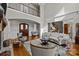 Spacious living room featuring hardwood floors, a fireplace, and plenty of natural light at 4008 Quintessa Dr, Matthews, NC 28104