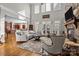 Sunlit living room featuring a stone fireplace, hardwood floors, tall ceilings, and large windows at 4008 Quintessa Dr, Matthews, NC 28104