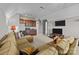 Spacious living room featuring plush seating, a small kitchenette, and a large window for ample natural light at 4008 Quintessa Dr, Matthews, NC 28104