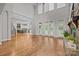 Spacious living room with tall windows, hardwood floors, and fireplace at 4008 Quintessa Dr, Matthews, NC 28104
