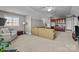 Spacious living room featuring plush seating, a small kitchenette, and a large window for ample natural light at 4008 Quintessa Dr, Matthews, NC 28104