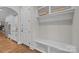 This mudroom features a convenient bench with cubbies and white cabinets, offering stylish storage for an organized entryway at 4008 Quintessa Dr, Matthews, NC 28104