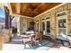 Covered outdoor patio with wood ceiling, fan, and a brick fireplace, perfect for entertaining and relaxation at 4008 Quintessa Dr, Matthews, NC 28104