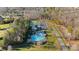 Aerial view of community pool, tennis court, parking lot and community area surrounded by lush trees at 4008 Quintessa Dr, Matthews, NC 28104