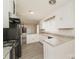 Galley kitchen with white cabinets, granite countertops, and modern appliances at 401 Pine St, Fort Mill, SC 29715