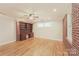 Home office with hardwood floors, built-in shelving, and brick accent wall at 401 Pine St, Fort Mill, SC 29715