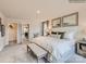 Main bedroom with plush bed and bench, featuring an ensuite and walk-in closet at 4084 Skyboat Cir, Fort Mill, SC 29715