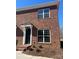 Two-story brick townhouse with white trim and a black door at 451 Beacon Nw St # 6, Concord, NC 28027