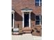 Brick townhouse with a black front door and small steps leading to the entrance at 451 Beacon Nw St # 6, Concord, NC 28027