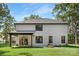 Rear exterior featuring a covered patio and fire pit seating area at 4605 Western Union School Rd, Waxhaw, NC 28173