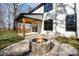 Inviting backyard patio with a stone fire pit, wood beams, and a covered porch at 4605 Western Union School Rd, Waxhaw, NC 28173