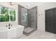 A bright bathroom with a soaking tub, glass shower, gray subway tile, and large window at 4605 Western Union School Rd, Waxhaw, NC 28173