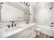 Bright bathroom with a dual-sink vanity, white marble-style tile, and modern black fixtures at 4605 Western Union School Rd, Waxhaw, NC 28173