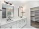 Bathroom features dual sinks, a white vanity, modern fixtures, and a glimpse into the walk-in closet at 4605 Western Union School Rd, Waxhaw, NC 28173