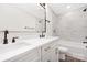 Bright bathroom featuring double sinks, modern gold hardware, and marble-look tile shower at 4605 Western Union School Rd, Waxhaw, NC 28173