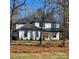 Stunning modern farmhouse with black trim, light wood accents, and a well-manicured lawn at 4605 Western Union School Rd, Waxhaw, NC 28173