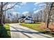 A long driveway leads to this new modern farmhouse with a well-manicured lawn at 4605 Western Union School Rd, Waxhaw, NC 28173