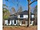 A beautifully designed modern farmhouse with a black roof and wooden front door at 4605 Western Union School Rd, Waxhaw, NC 28173