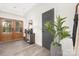 Bright foyer featuring hardwood floors, a wooden front door, stylish furniture, and a modern plant at 4605 Western Union School Rd, Waxhaw, NC 28173