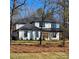 Beautiful two-story home featuring a modern white facade with black accents, wood-look door and a manicured front yard at 4605 Western Union School Rd, Waxhaw, NC 28173