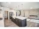 Open-concept kitchen with gray island, fireplace, stainless appliances, and white cabinetry at 4605 Western Union School Rd, Waxhaw, NC 28173