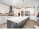 Bright kitchen with stainless steel appliances, gray island, subway tile backsplash, and pendant lights at 4605 Western Union School Rd, Waxhaw, NC 28173